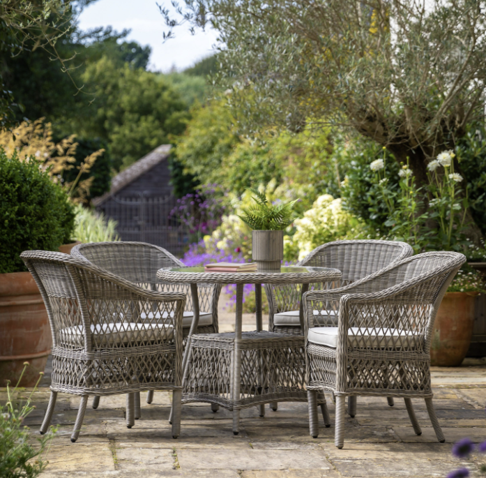 Aurina Pop UP Ltd Menton round garden dining table with chairs in outdoor setting, lifestyle view