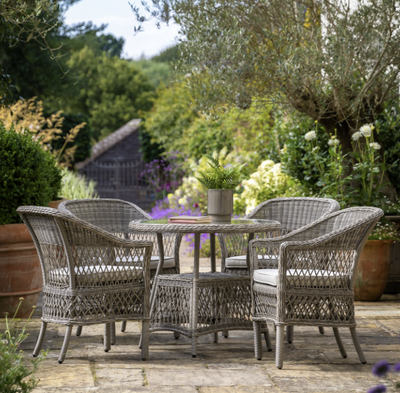 Aurina Pop UP Ltd Menton round garden dining table with chairs in outdoor setting, lifestyle view